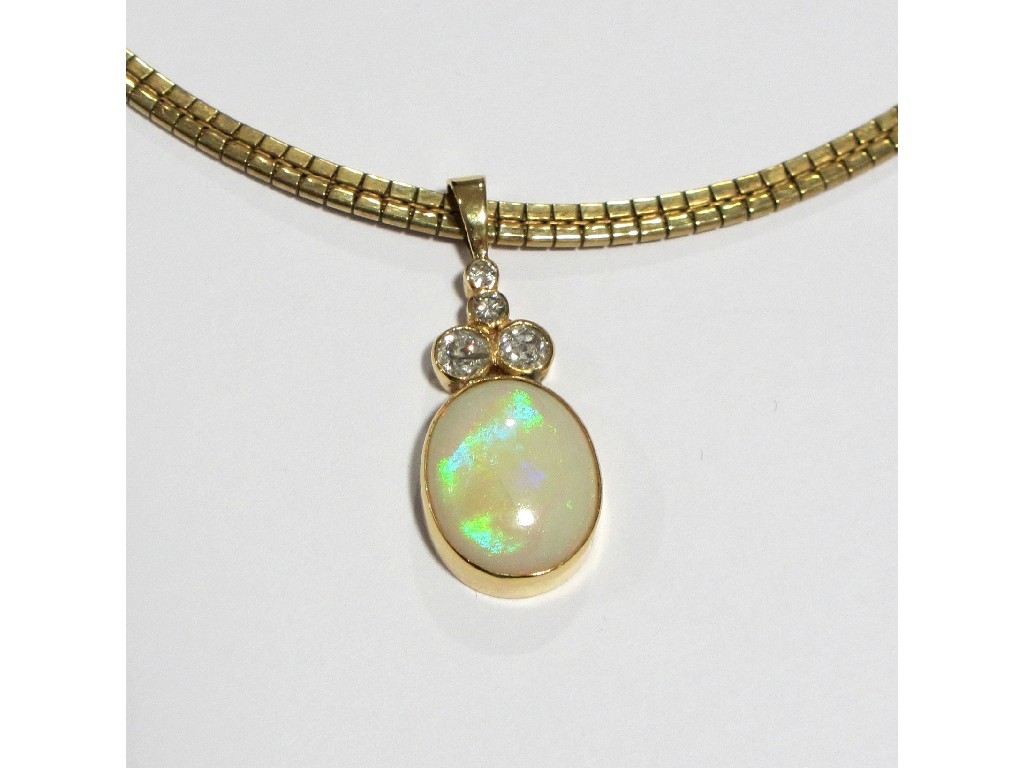 Appraisal: A gold mounted opal and diamond pendant with oval opal