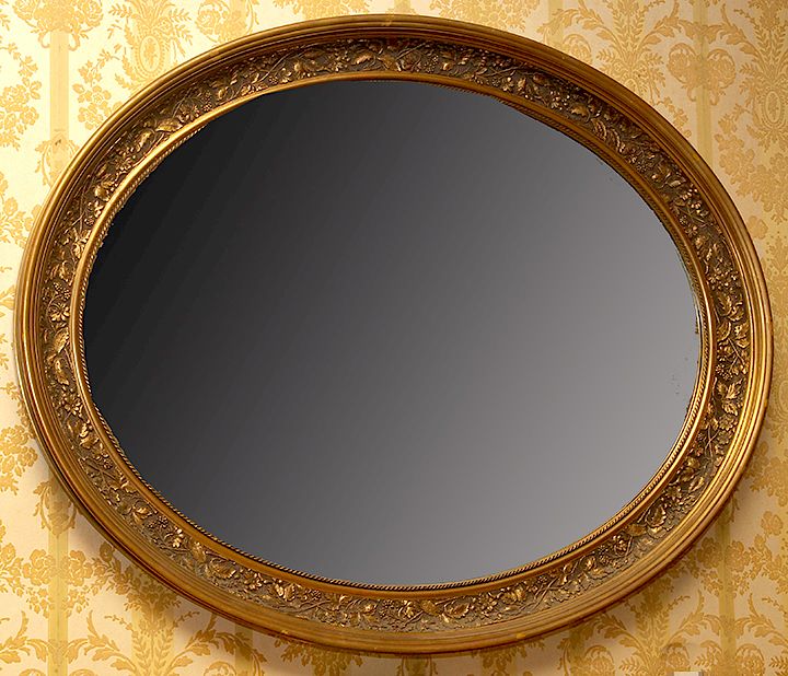 Appraisal: Oval Carved Mirror A gold gilt oval carved mirror in