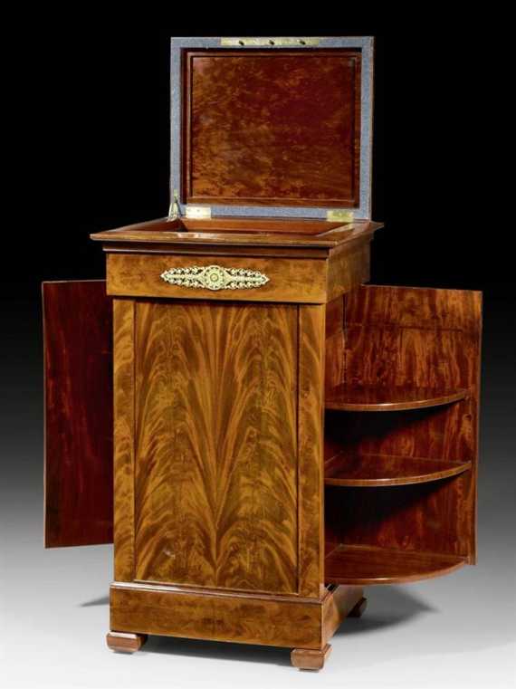 Appraisal: POSTAMENT EN ARMOIRE Empire Paris circa Flame mahogany Push-button openings