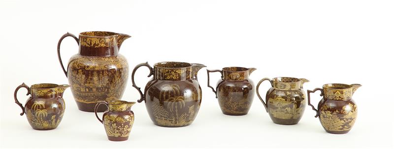 Appraisal: GROUP OF SEVEN REDDISH-BROWN-GLAZED YELLOW TRANSFERWARE POTTERY MILK AND CREAM