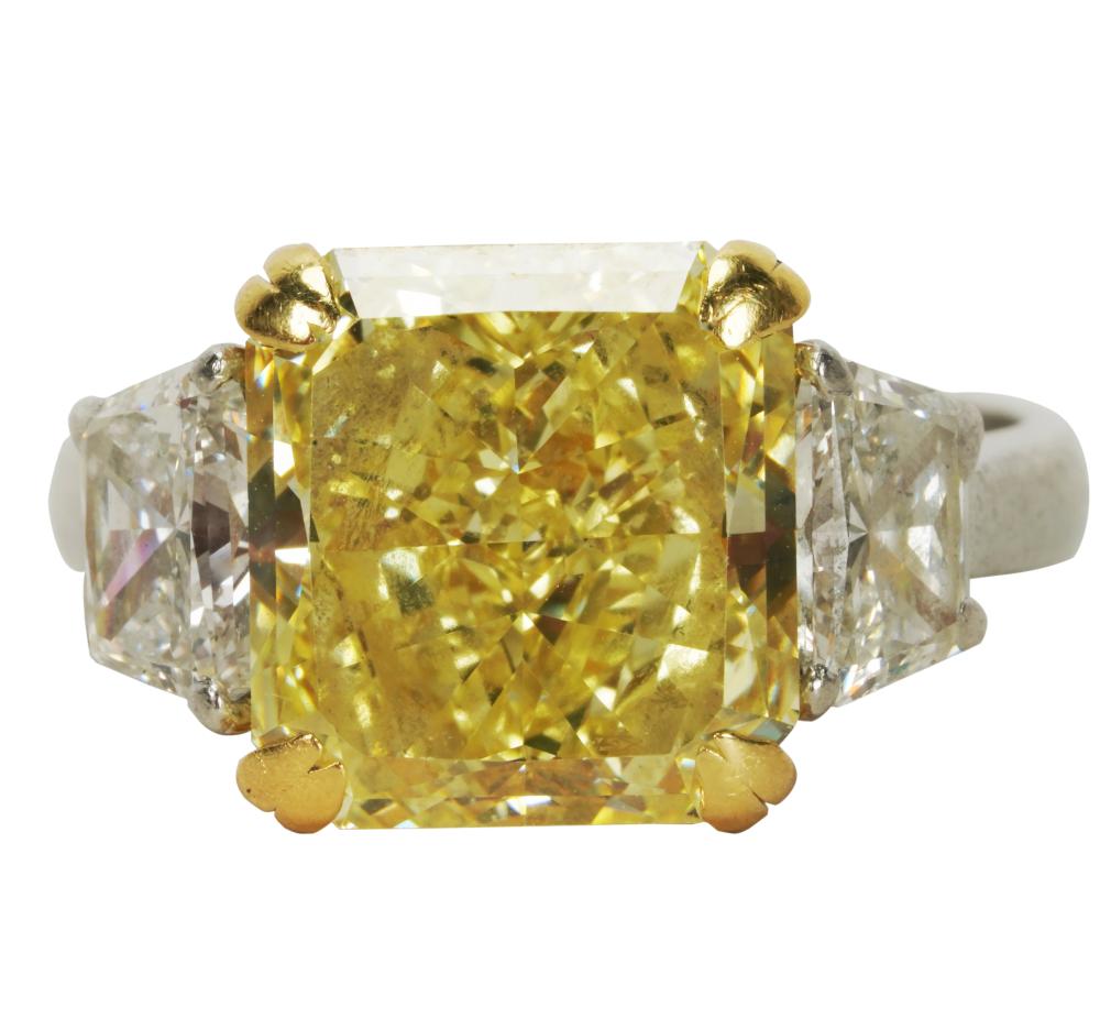 Appraisal: PLATINUM YELLOW DIAMOND RINGcentering one cut-corner rectangular modified brilliant cut