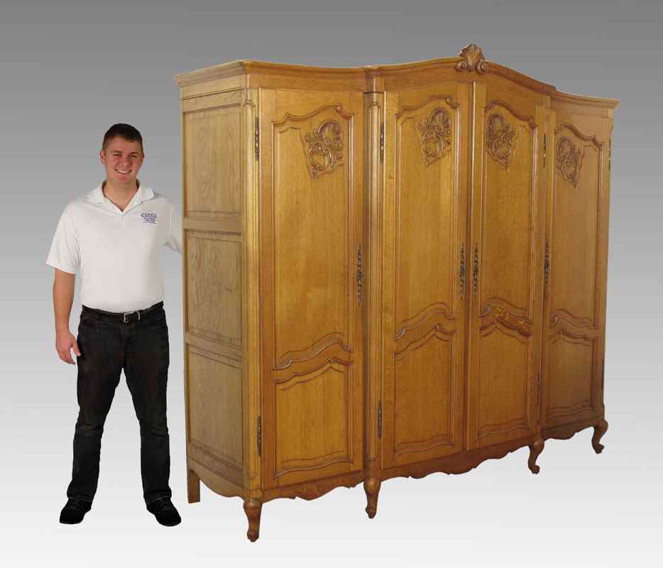 Appraisal: COUNTRY FRENCH OAK FOUR DOOR ARMOIRE Carved crest with carved