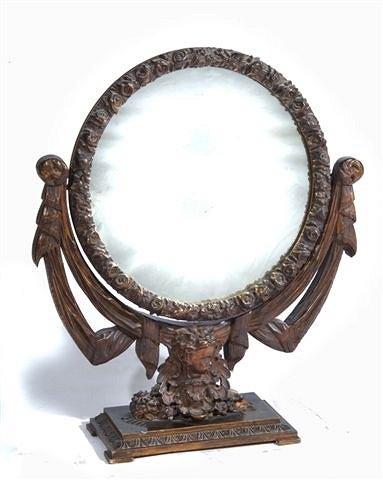 Appraisal: AN ITALIANATE PLASTER DRESSING MIRROR with putti decoration on a