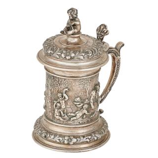 Appraisal: AUSTRIAN SILVER REPOUSSE TANKARD Depicting Bacchus and drunken Selinus floral