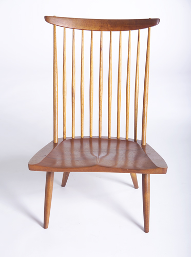 Appraisal: GEORGE NAKASHIMA Armless lounge chair with hickory spindles and saddle