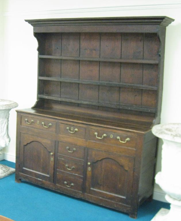 Appraisal: An antique oak Welsh Dresser with boarded rack the enclosed