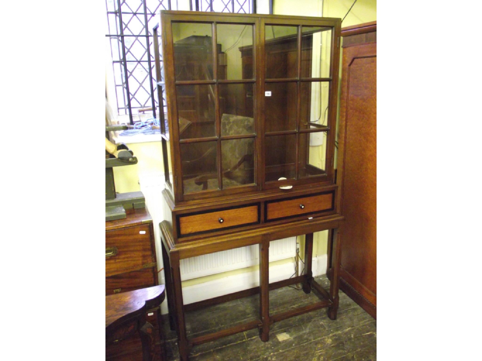 Appraisal: An Arts Crafts style display cabinet on stand the upper