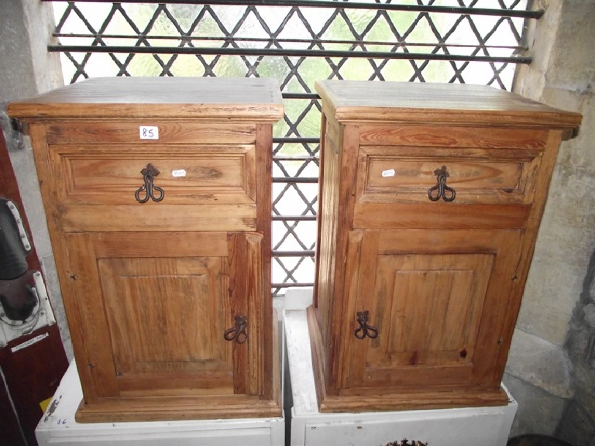 Appraisal: A pair of contemporary Mexican pine bedside cupboards each enclosed