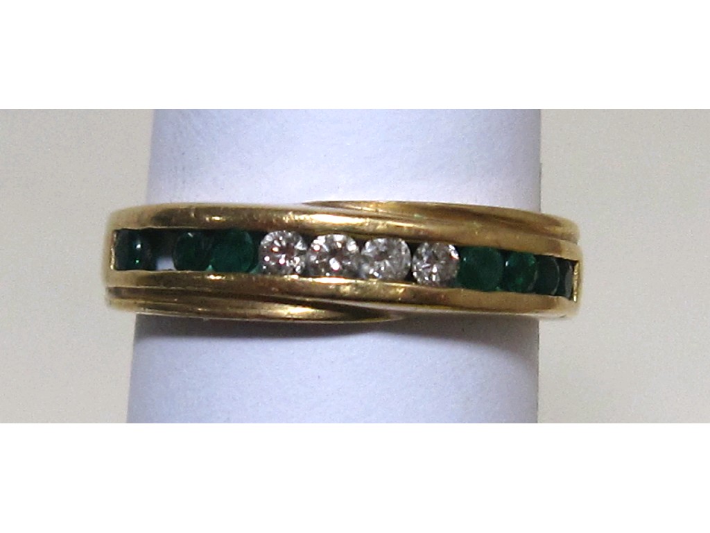 Appraisal: Gold channel set emerald and diamond half hoop ring one