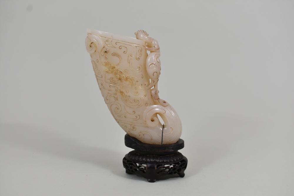 Appraisal: CHINESE WHITE JADE RHYTON CUP VASEThe translucent vessel with a