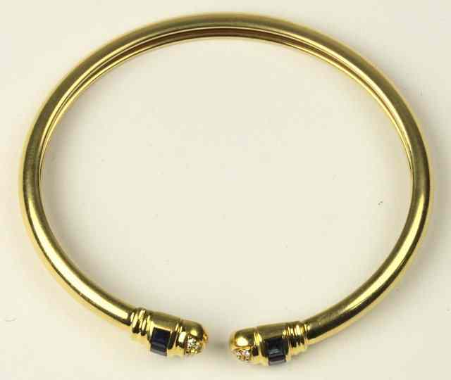 Appraisal: A sapphire and diamond set ct yellow gold torque style