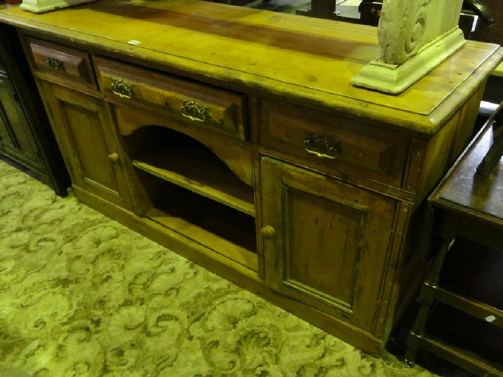 Appraisal: A stripped reclaimed pine dresser base fitted with three frieze