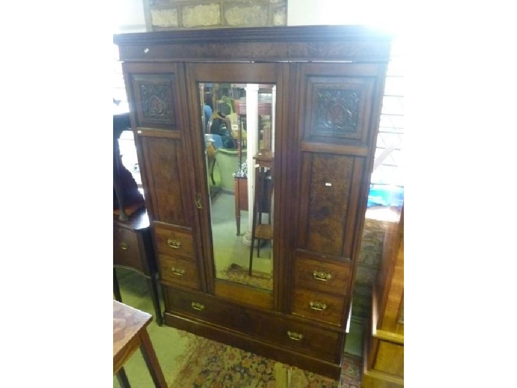 Appraisal: A late Victorian walnut wardrobe enclosed by a central three