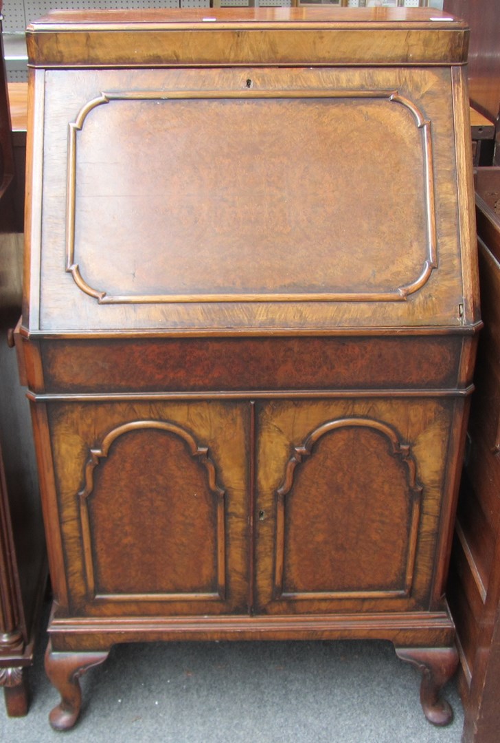 Appraisal: A th century figured walnut drinks cabinet in the form