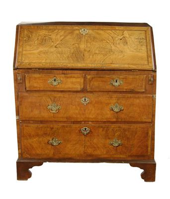 Appraisal: A walnut bureau the hinged fall to an interior fitted