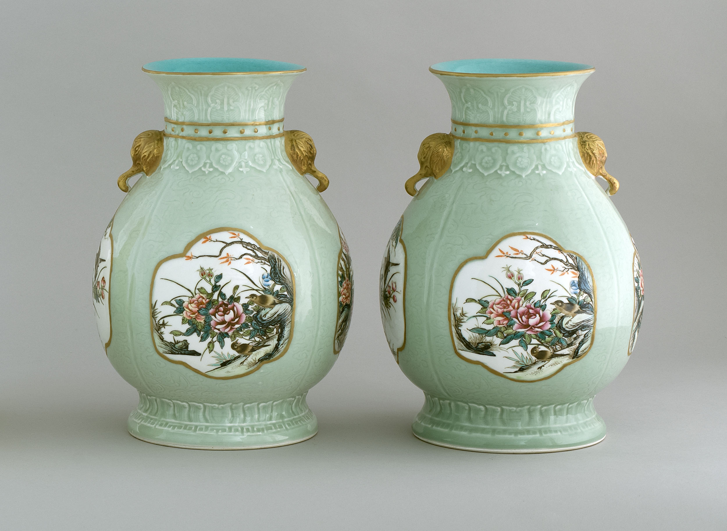 Appraisal: PAIR OF FAMILLE ROSE-ON-CELADON PORCELAIN VASES In ovoid form With