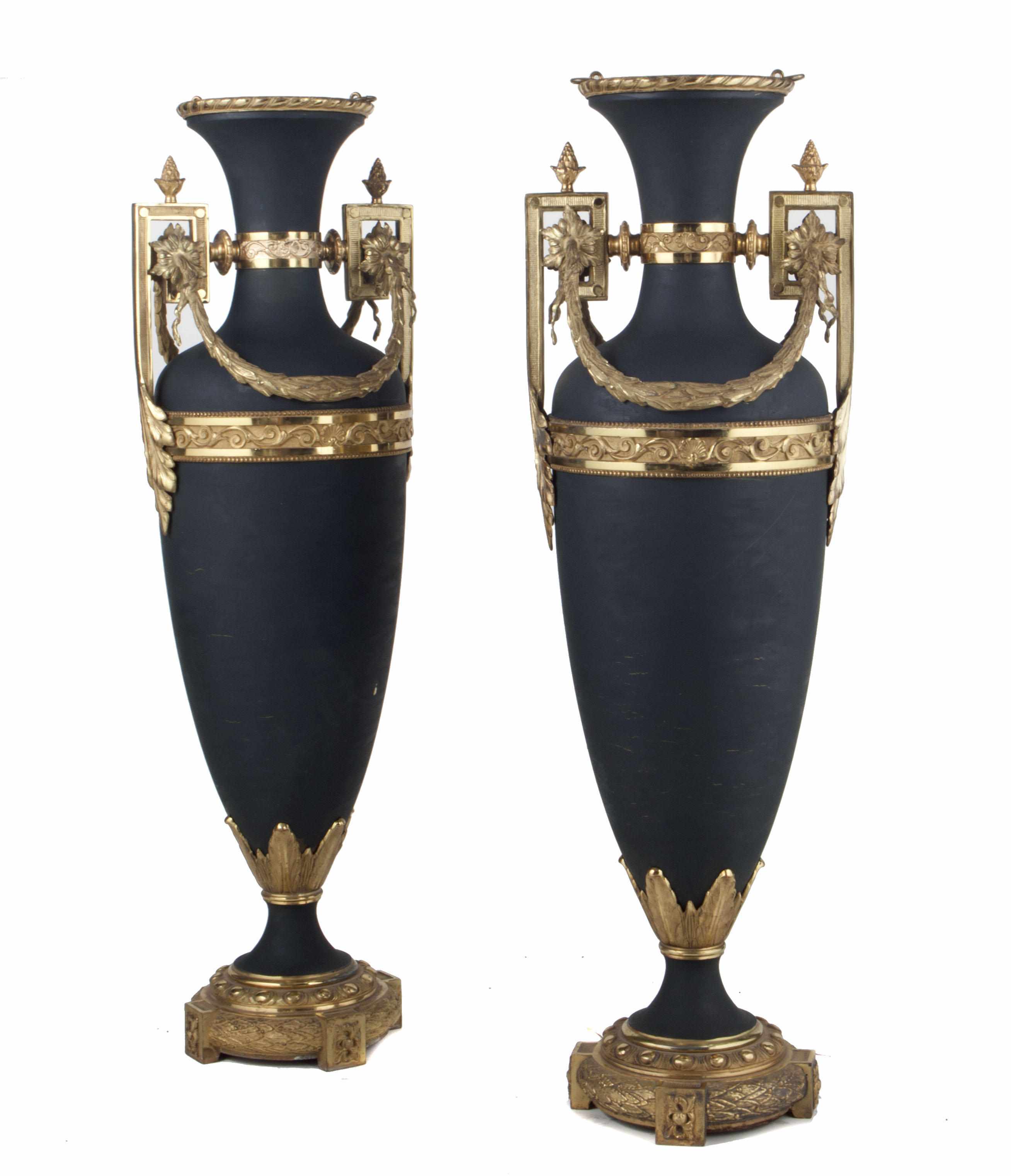 Appraisal: A pair of Neoclassical style gilt bronze mounted tle urns