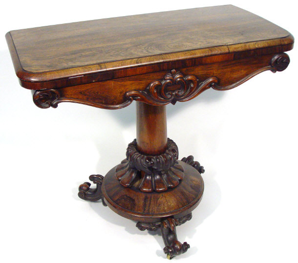 Appraisal: th century rosewood swivel top card table supported by a