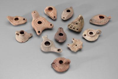 Appraisal: Twelve ancient terracotta lamps varying forms and surface decoration one