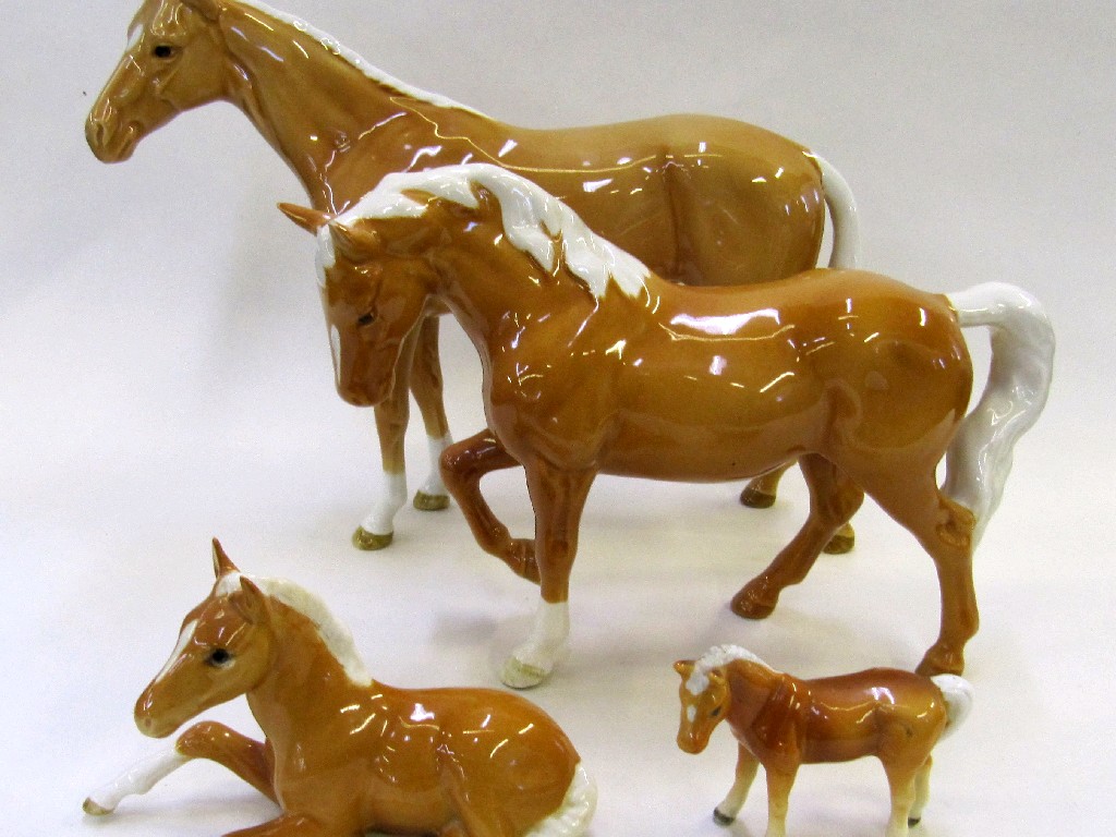 Appraisal: Four Beswick Palomino horses to include a Stocky Jogging Mare