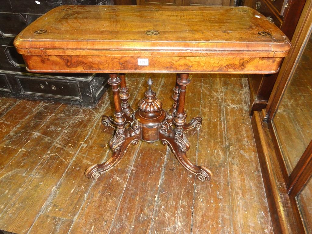 Appraisal: A Victorian walnut and figured walnut veneered fold over top