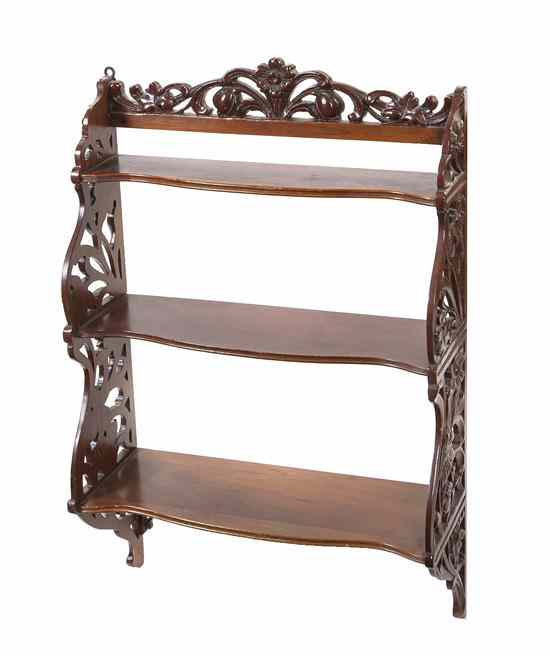 Appraisal: An Art Nouveau Style Carved Hanging Shelf having multiple shelves