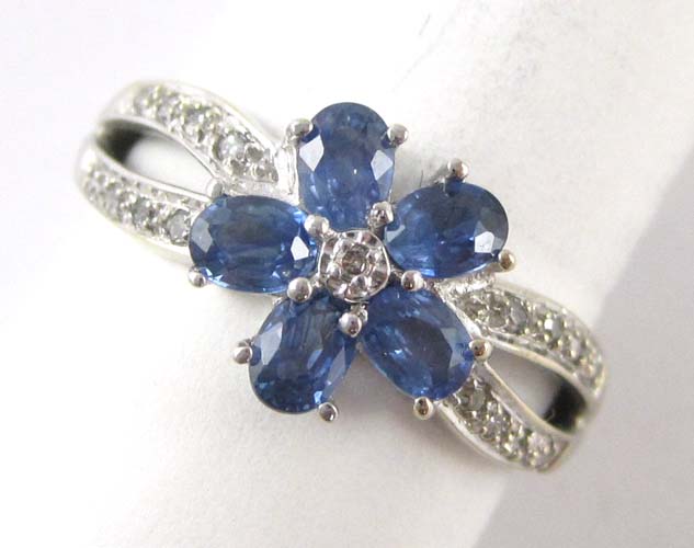 Appraisal: SAPPHIRE DIAMOND AND FOURTEEN KARAT GOLD RING set with round-cut