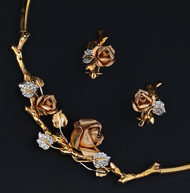 Appraisal: A diamond set floral necklace and earrings suite the necklace