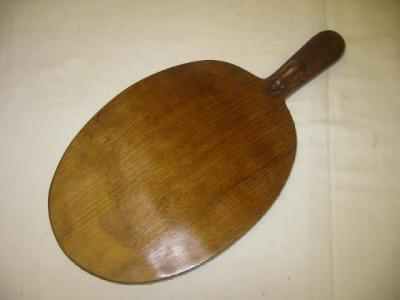 Appraisal: AN ADZED OAK CHEESEBOARD by Robert Mouseman Thompson of oval