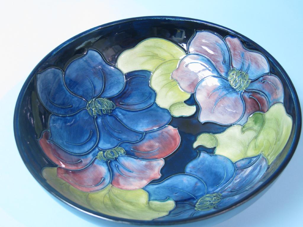 Appraisal: A Moorcroft Bowl hibiscus pattern on a blue ground