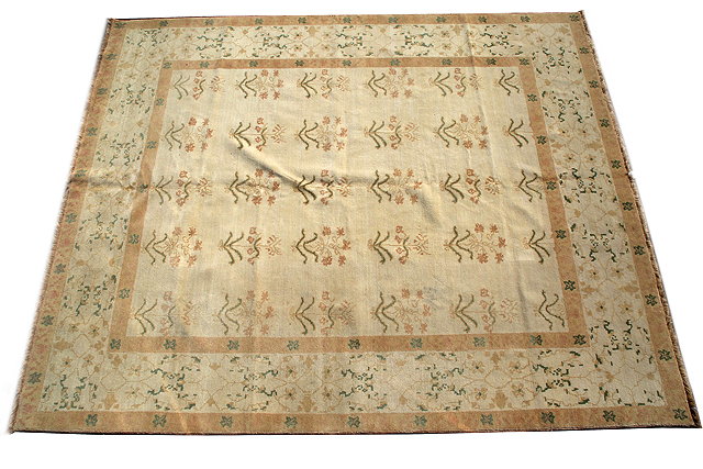 Appraisal: A CREAM GROUND RUG with a banded border and rows