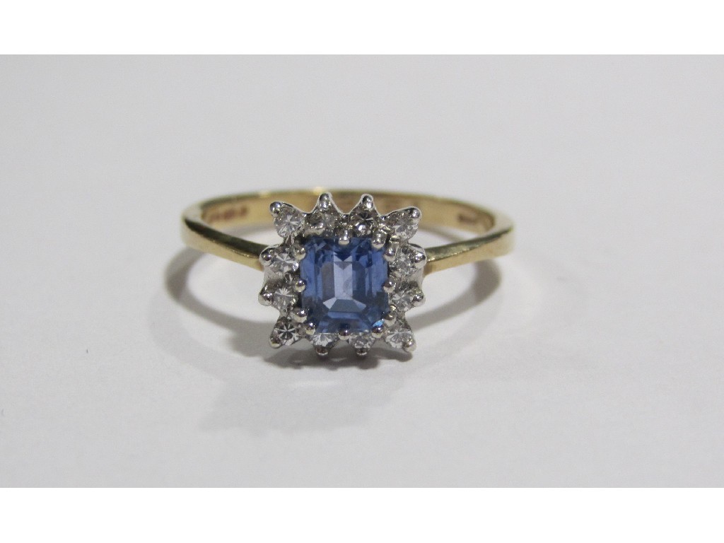 Appraisal: A nine carat gold Ceylon sapphire and diamond cluster ring