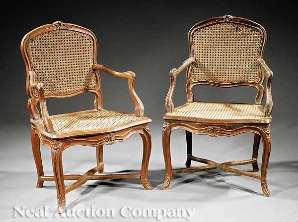 Appraisal: A Pair of Louis XV Carved Walnut and Caned Fauteuils