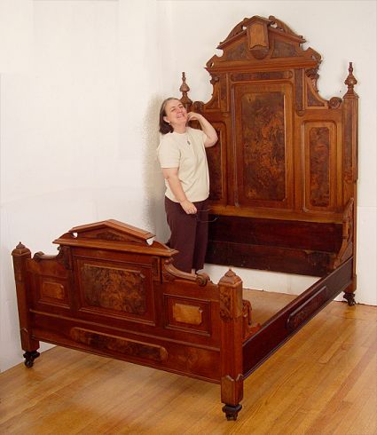 Appraisal: HIGH RENAISSANCE REVIVAL VICTORIAN BED Mixed woods featuring richly grained