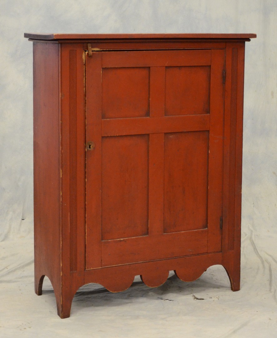 Appraisal: Red painted single door wall cupboard panel door flanked by