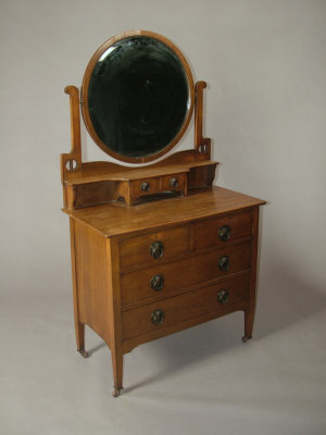 Appraisal: A Liberty's style oak dressing table the raised circular mirror