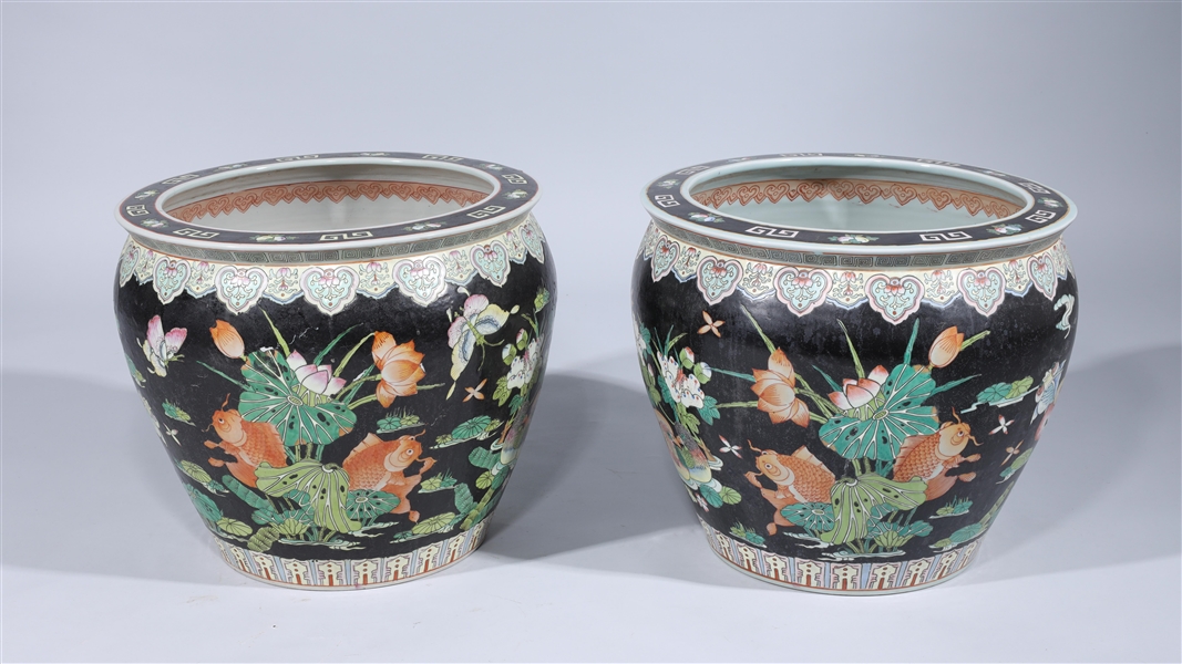 Appraisal: Pair of Chinese black ground famille rose enameled porcelain fish