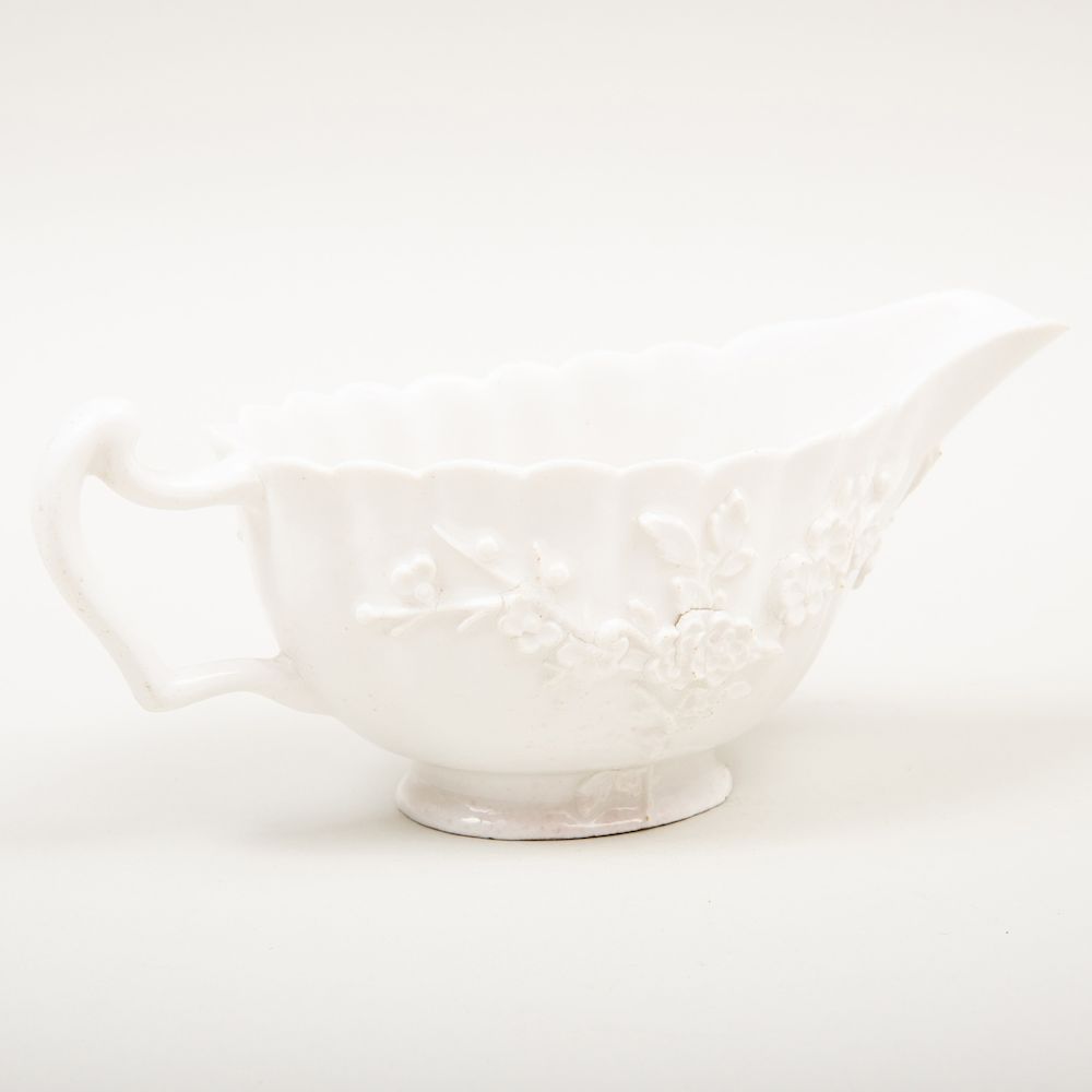 Appraisal: Bow White Glazed Porcelain Sauceboat with Applied Prunus Decoration in