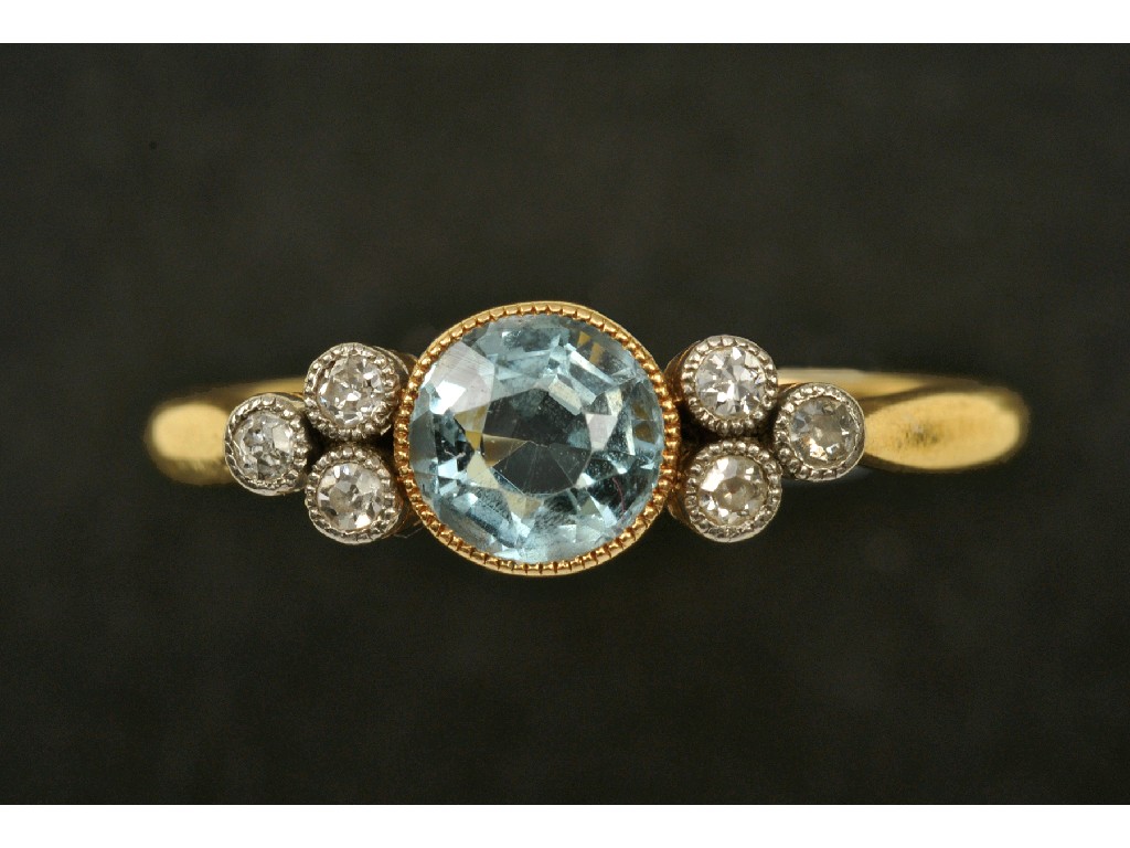 Appraisal: An Aquamarine and Diamond Ring the central circular-cut aquamarine collet-set