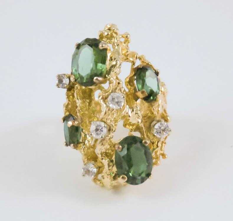 Appraisal: SYNTHETIC EMERALD AND FOURTEEN KARAT GOLD RING set with four