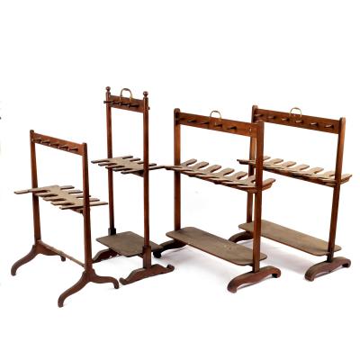 Appraisal: A pair of mahogany boot racks with brass handles and