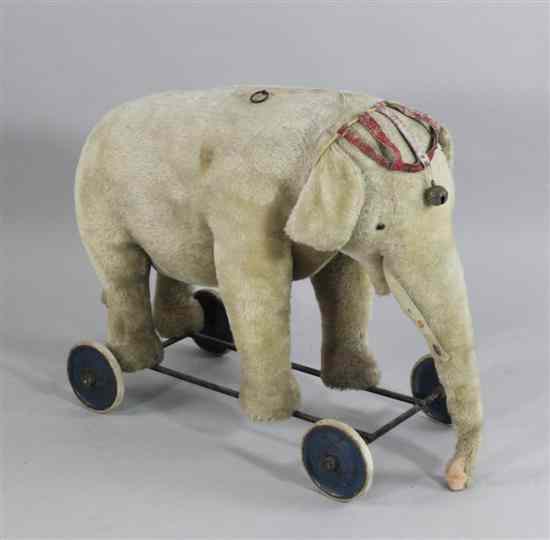 Appraisal: A Steiff pull-along elephant with spoke wheels button to ear