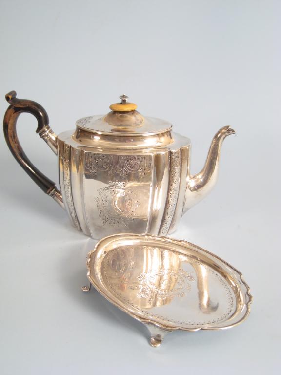 Appraisal: A George III shaped oval Teapot and Stand with engraved