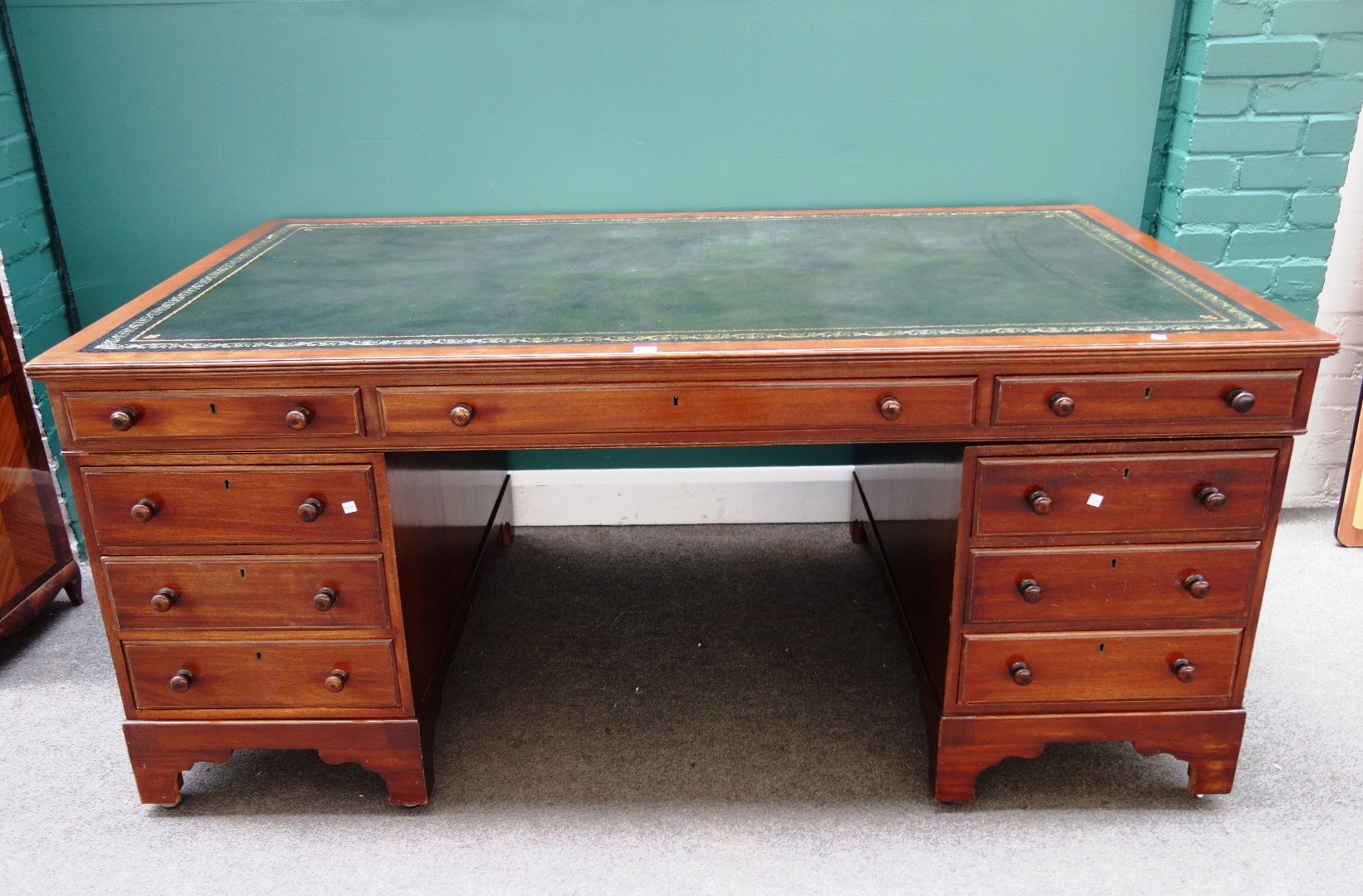 Appraisal: An th century style mahogany twin pedestal desk with nine