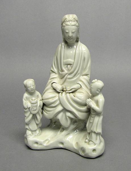 Appraisal: A Dehua seated Guanyin and attendants th Century The central