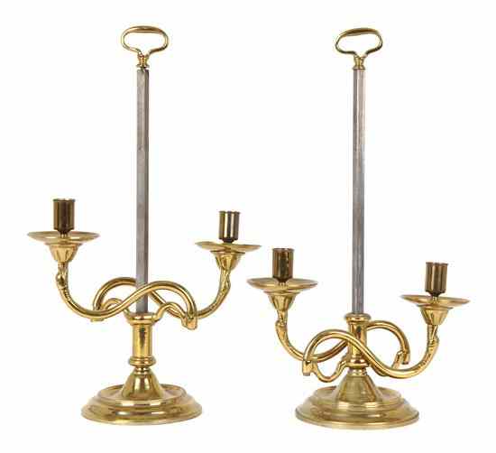 Appraisal: A Pair of Continental Brass Candelabra having scrolling arms with