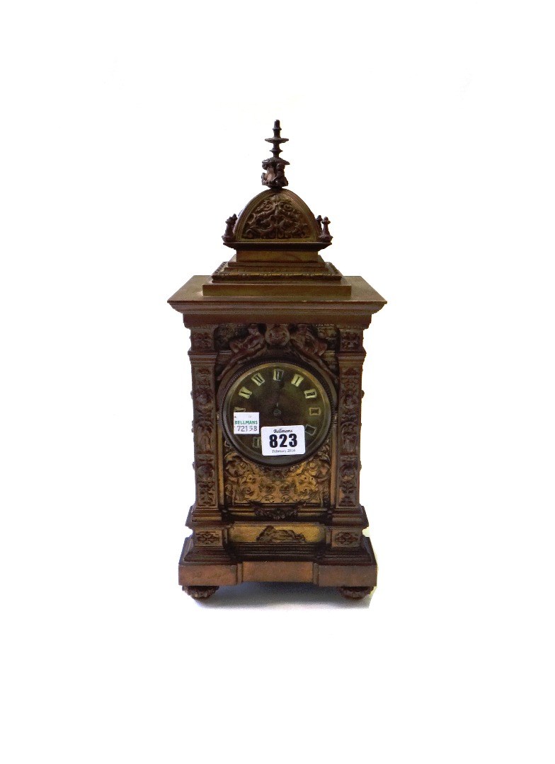 Appraisal: A Victorian bronze mantel clock the domed case relief cast