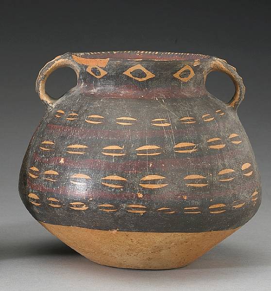 Appraisal: A Neolithic handled jar with cowrie shell decoration Majiayao Culture