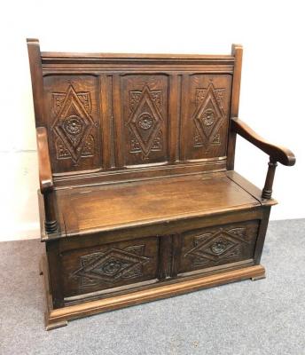 Appraisal: A th Century style oak settle with carved three-panel back