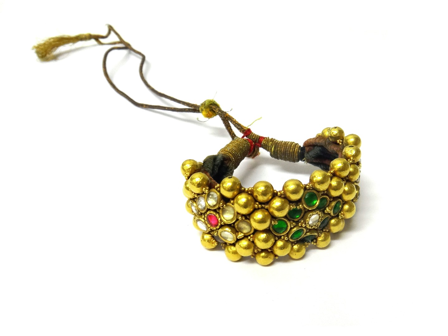 Appraisal: A gold foil cased bead and paste wide bracelet having